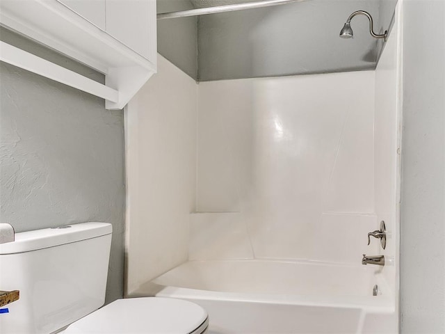 bathroom with shower / bathing tub combination and toilet