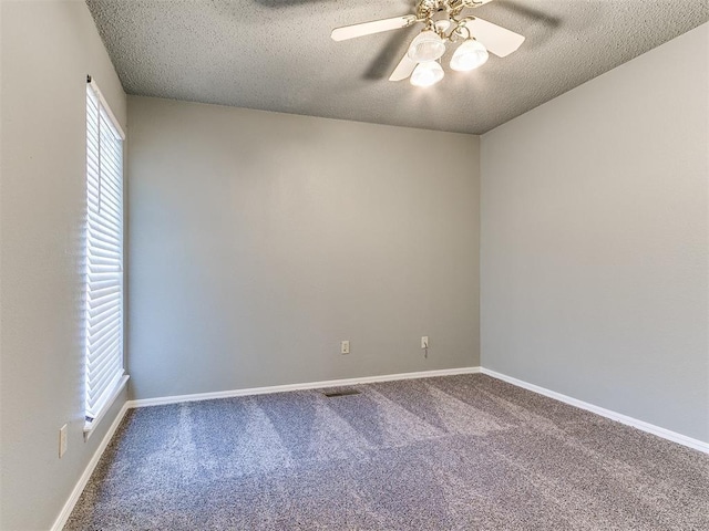 carpeted spare room with ceiling fan and a textured ceiling