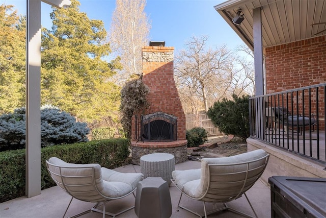 view of patio / terrace featuring an outdoor brick fireplace