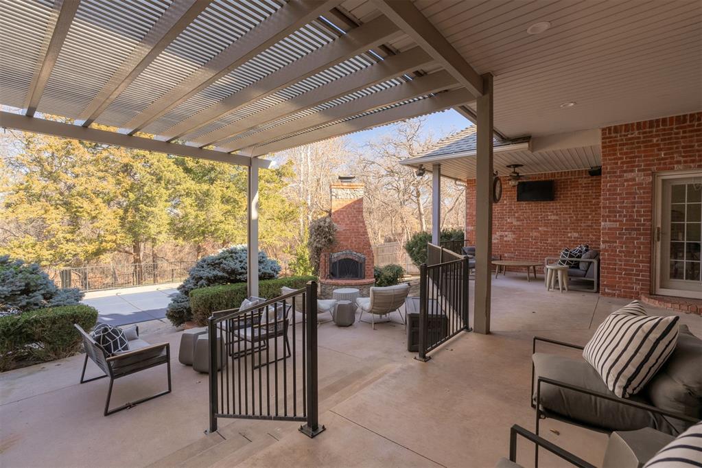 view of patio with a pergola and an outdoor living space with a fireplace