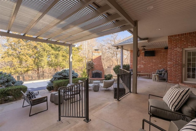 view of patio with a pergola and an outdoor living space with a fireplace