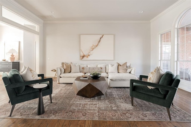 living room featuring wood-type flooring and crown molding