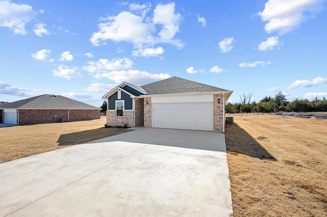 single story home with a garage and a front yard