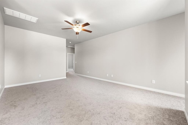 carpeted spare room featuring ceiling fan