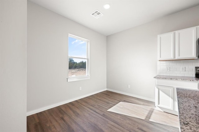 unfurnished dining area featuring hardwood / wood-style floors