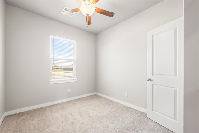 spare room with light colored carpet and ceiling fan