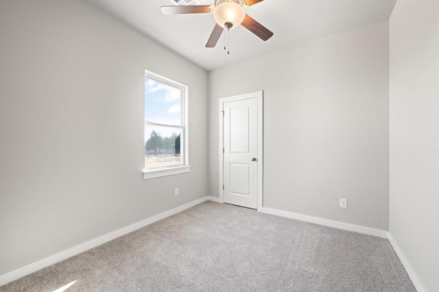 carpeted empty room with ceiling fan