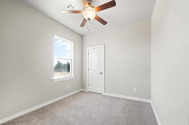 carpeted empty room featuring ceiling fan