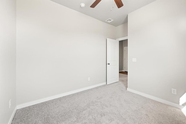 empty room featuring light colored carpet and ceiling fan