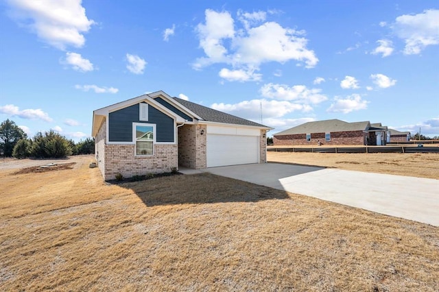 view of front of house featuring a garage and a front lawn