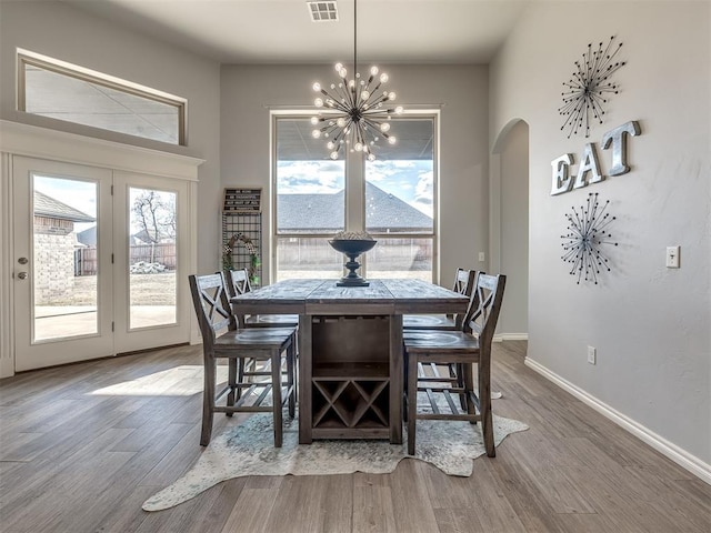 dining area featuring hardwood / wood-style floors and a chandelier