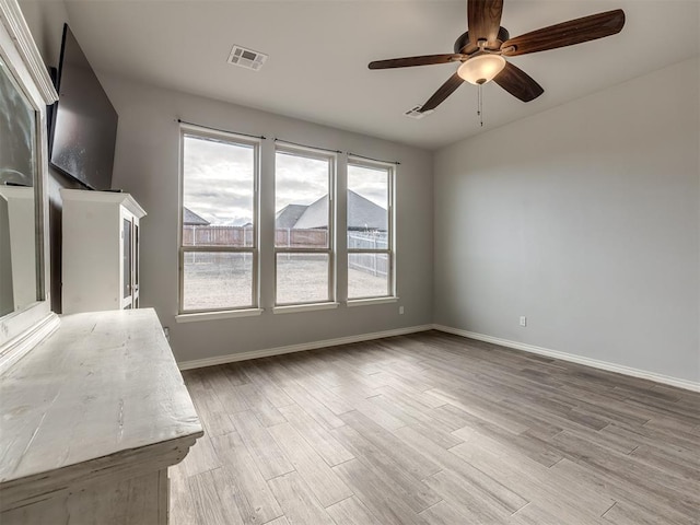 unfurnished living room featuring hardwood / wood-style floors and ceiling fan