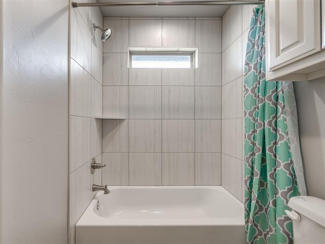 bathroom with toilet and shower / bath combo