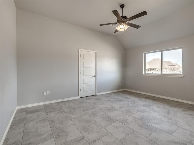 tiled empty room featuring lofted ceiling and ceiling fan