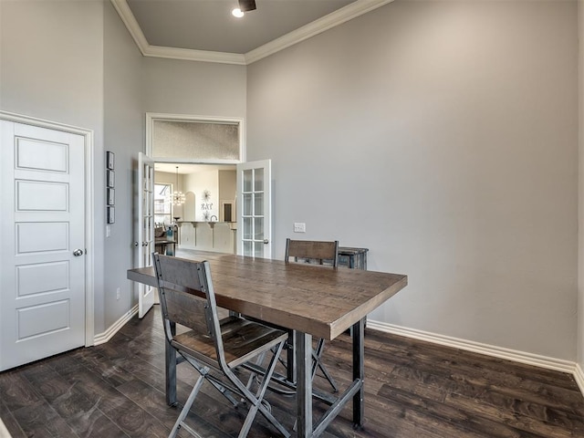 dining area with a high ceiling, crown molding, and dark wood-type flooring