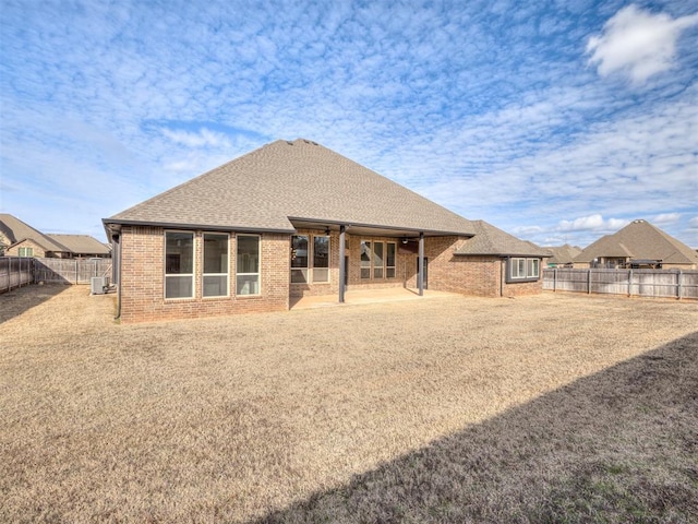 back of property with central AC unit and a patio