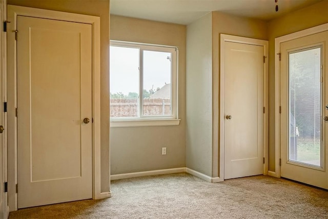 unfurnished bedroom featuring light carpet