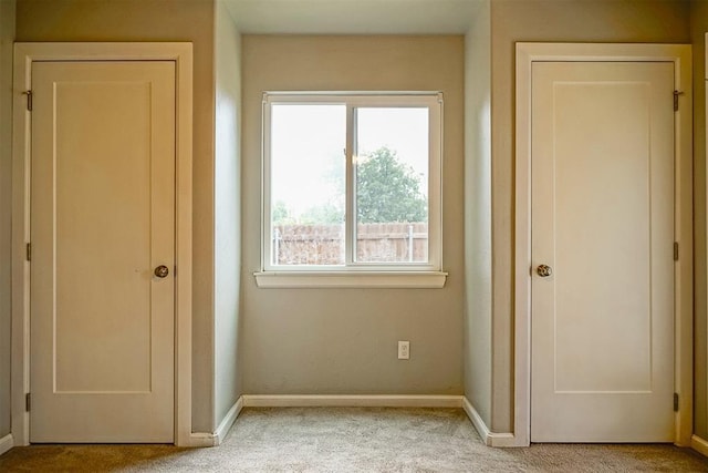 unfurnished bedroom featuring light carpet