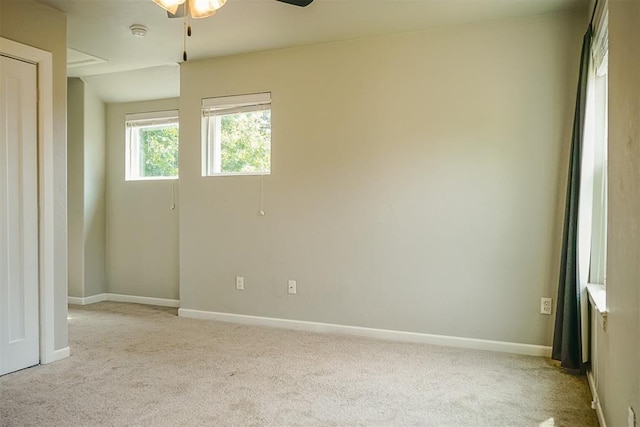 carpeted empty room featuring ceiling fan