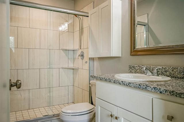 bathroom with vanity, toilet, and a shower with shower door