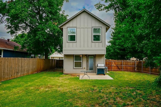 back of property with a yard and a patio