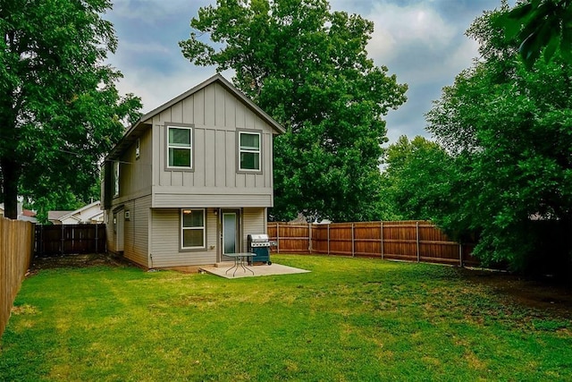 rear view of house with a patio and a yard