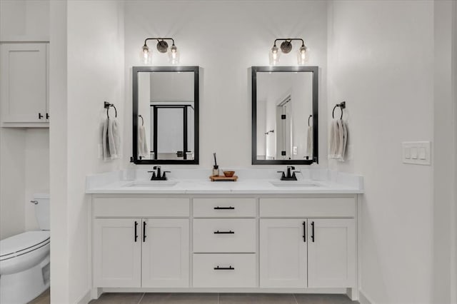 bathroom with tile patterned floors, vanity, and toilet