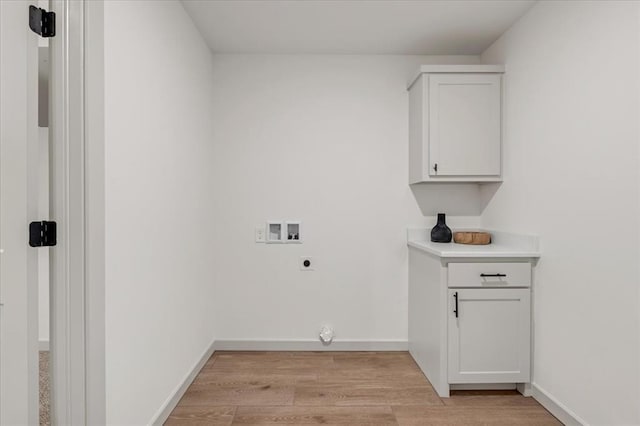 washroom with hookup for a washing machine, light hardwood / wood-style flooring, and hookup for an electric dryer