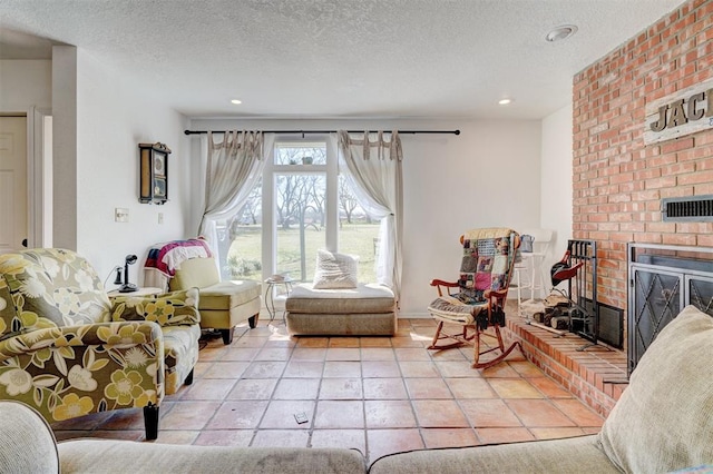 living area with a brick fireplace, light tile patterned floors, and a textured ceiling