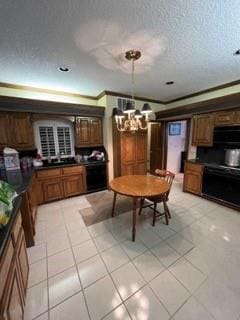 kitchen with light tile patterned flooring, decorative light fixtures, ornamental molding, range, and a notable chandelier