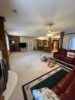 carpeted living room featuring ceiling fan