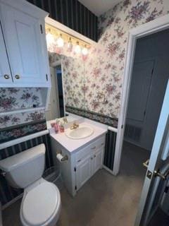 bathroom with vanity and toilet