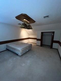 unfurnished bedroom featuring vaulted ceiling and carpet