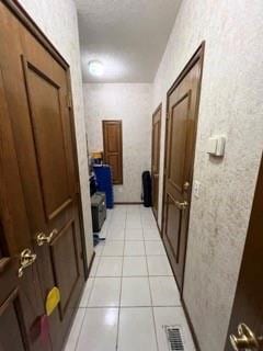 hallway featuring light tile patterned flooring