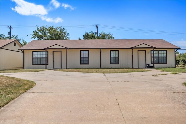 ranch-style home with a front lawn