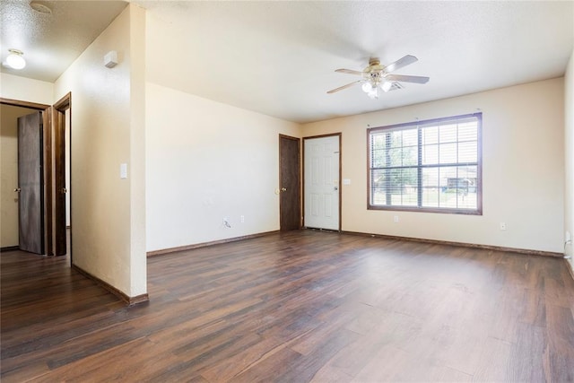 spare room featuring ceiling fan, dark hardwood / wood-style flooring, and a textured ceiling