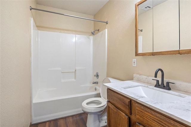 full bathroom featuring vanity, hardwood / wood-style flooring,  shower combination, and toilet