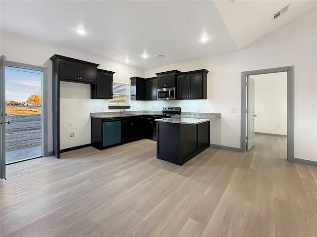 kitchen with light stone counters, stainless steel appliances, and light wood-type flooring