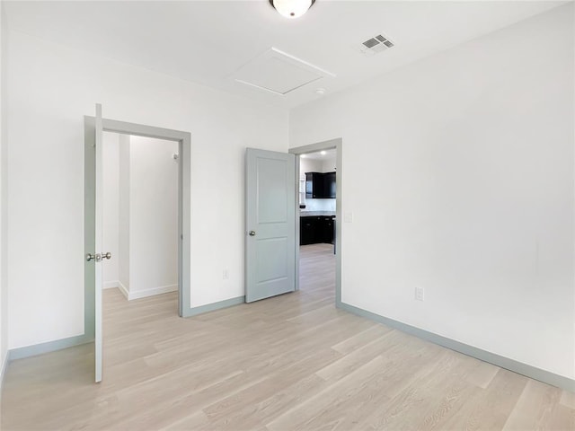 unfurnished bedroom with light wood-type flooring