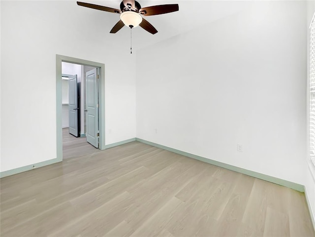 spare room featuring ceiling fan and light wood-type flooring