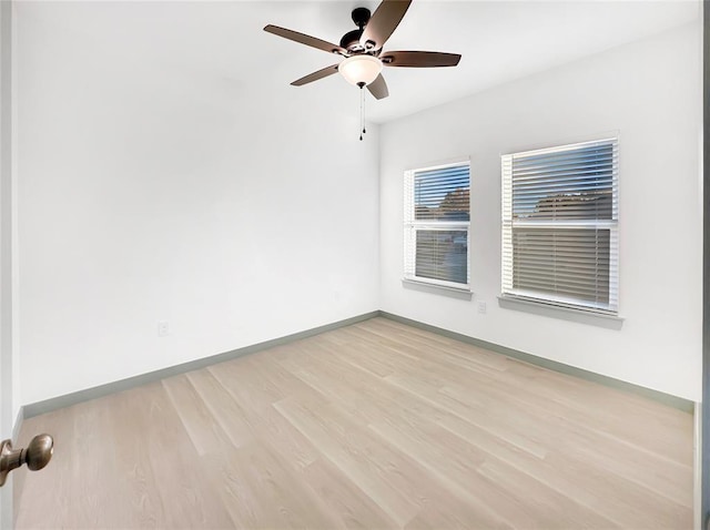 empty room with ceiling fan and light hardwood / wood-style floors