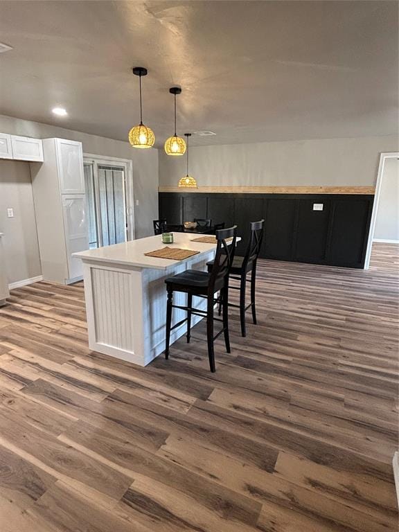 kitchen with decorative light fixtures, dark wood finished floors, light countertops, white cabinetry, and dark cabinets