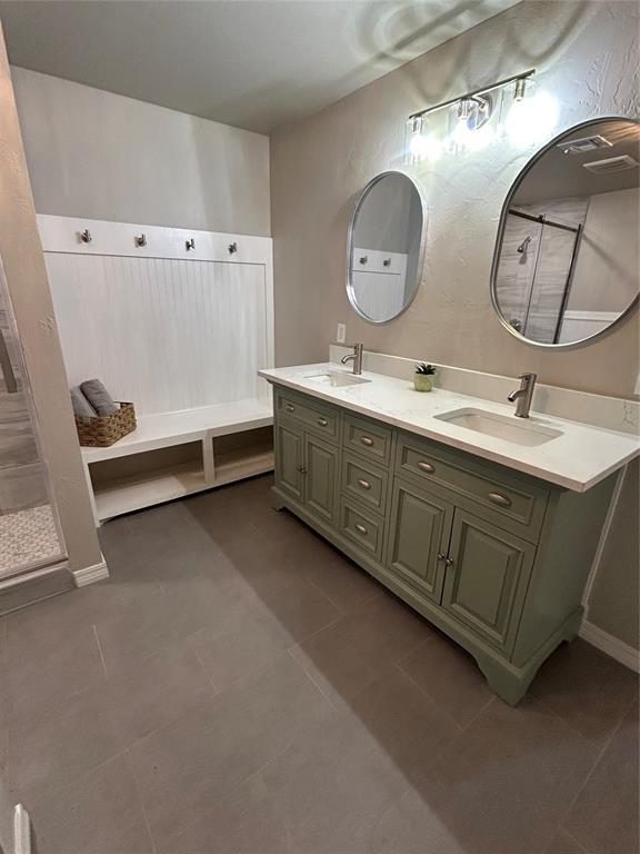 full bath featuring double vanity and a sink