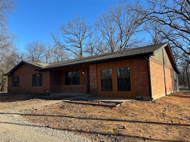 ranch-style home with brick siding and board and batten siding