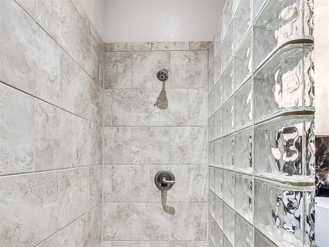 interior details featuring a tile shower