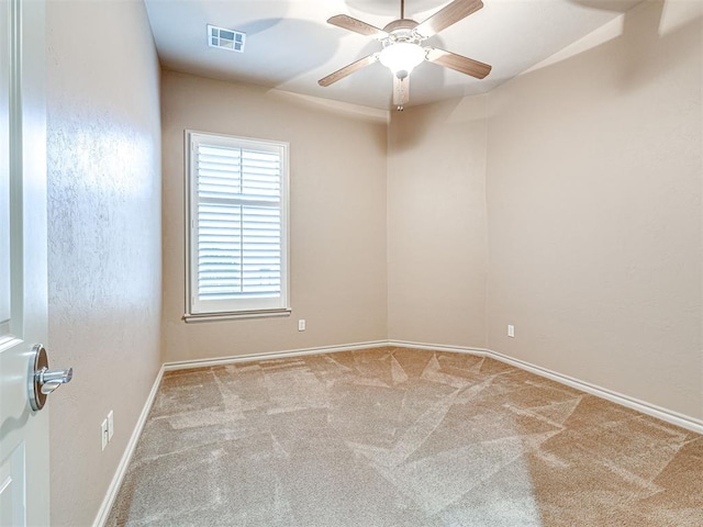 empty room with light carpet and ceiling fan