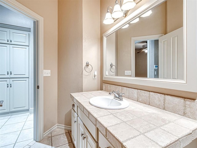 bathroom with ceiling fan, tile patterned floors, and vanity