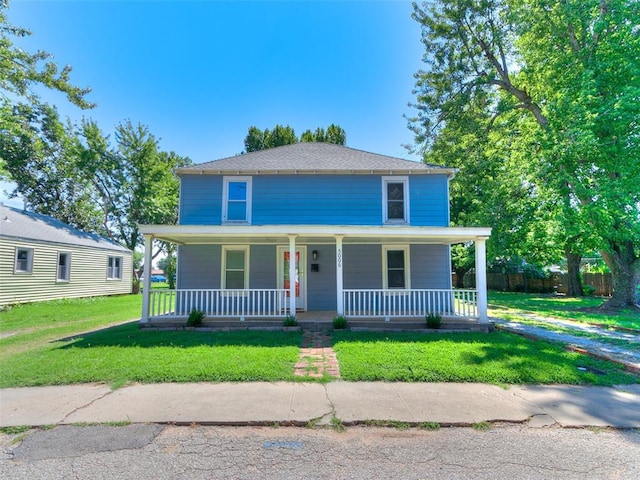 view of front of property featuring a front lawn and a porch