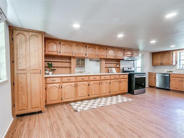 kitchen featuring stainless steel appliances, sink, and light hardwood / wood-style floors