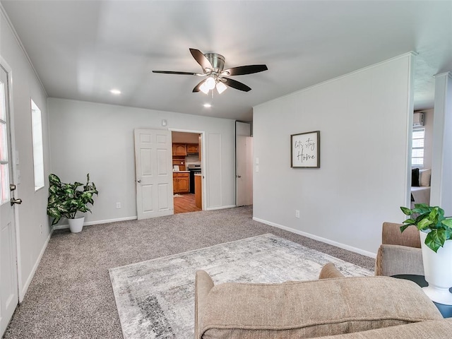 carpeted living room with ceiling fan